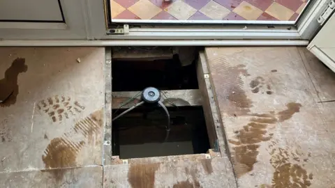 Shariqua Ahmed  Floorboard inside a flood-affected house