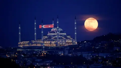 Reuters The full moon, also known as the Supermoon or Flower Moon, rises above the Camlica Mosque during the spread of the coronavirus disease (COVID-19), in Istanbul, Turkey