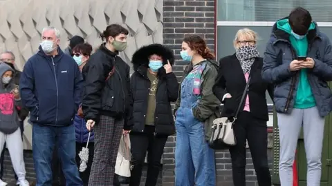 PA Media People queuing outside walk-in test centre in Liverpool