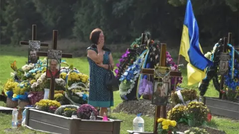 Reuters A woman reacts as she visits the tomb of her relative, a Ukrainian serviceman who was killed in a fight against Russian troops, amid Russia's attack on Ukraine, during the Independence Day in Lviv, Ukraine August 24, 2022.