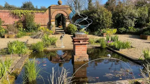 Shaun Whitmore/BBC A pond in East Ruston Old Vicarage garden