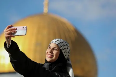 Jamal Awad / Reuters A Palestinian woman takes a selfie