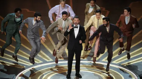 Reuters Jimmy Kimmel gets danced off the stage while hosting the Oscars show at the 95th Academy Awards in Hollywood, Los Angeles, California, U.S., March 12, 2023