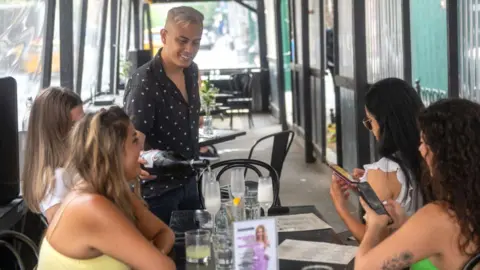 A group of women being served in an NYC restaurant