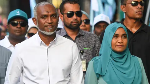 President Mohamed Muizzu along with his supporters take part in an election campaign rally