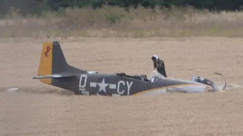 Paul Tolliday/Blue Sky Aerial Services Pilot and Mustang in field