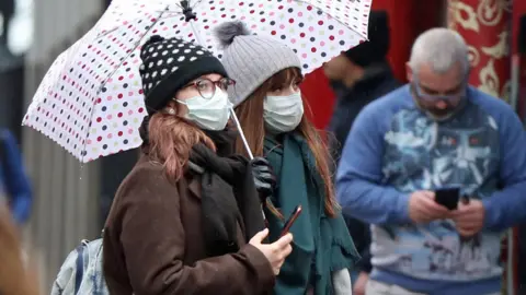 Luciana Guerra/PA Wire Women wearing face masks in Soho, London