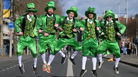 Charles McQuillan A group in fancy dress pose for a photo as Dubliners prepare to celebrate St Patrick's Day on March 17, 2022 in Dublin, Ireland. St Patrick's Day celebrations return to the streets of Dublin after a two-year absence, due to the Covid-19 pandemic.