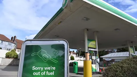 EPA Petrol station in London, 4 October - sign says "sorry we're out of fuel"