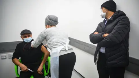 Getty Images Man getting vaccine