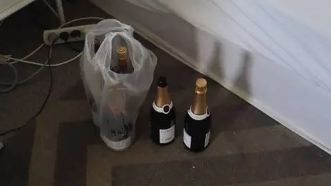 Esperance Police Bottles of champagne sit next to a bed where the intruder was arrested