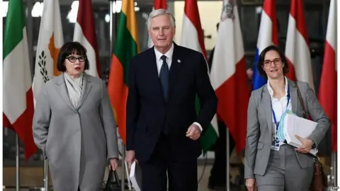 AFP Michel Barnier and his negotiating team arrive at the EU's headquarters