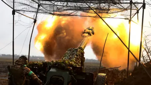 Reuters A Ukrainian soldiers fires a cannon. File photo