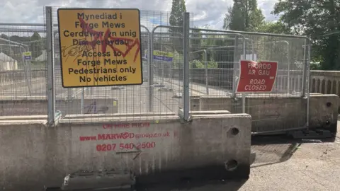 BBC The bridge blocked off with signage, gates and concrete blocks