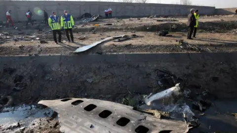 EPA Search and rescue teams comb the wreckage of a Boeing 737 that crashed near Imam Khomeini Airport