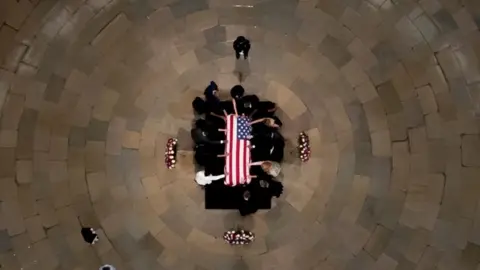 AFP Members of the Faith and Politics Institute pause for prayers to pay their respects to John Lewis