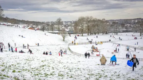 Getty Images People enjoy the snow in Cheetham Park in Stalybridge on 29 December 2020 in Stalybridge, England