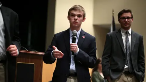 Getty Images Tyler Ruzich (C), 17, of Prairie Village, Kansas, speaks at a forum.