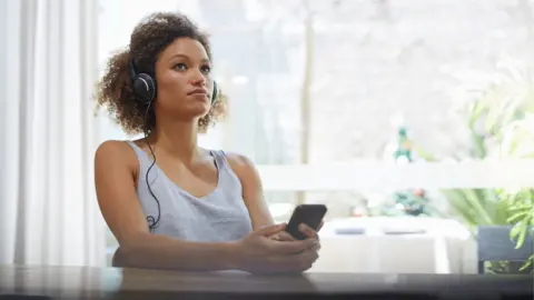 Getty Images Stock image of a woman listening to music