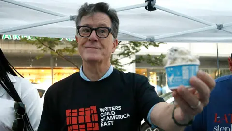 Getty Images Stephen Colbert serves ice cream as Animation writers, who are members of the Writers Guild of America, continue to picket in front of Warner Brothers/Discovery on July 25, 2023 in New York City