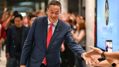 Getty Images Pheu Thai Party's Srettha Thavisin (C), approved by Thai lawmakers to become the kingdom's 30th prime minister, greets supporters at the party headquarters after the parliament's prime ministerial vote in Bangkok on August 22, 2023.