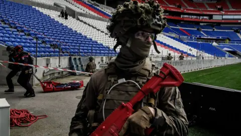 Getty Images A soldier taking part in a counter-terrorism exercise at an Olympic stadium in Paris