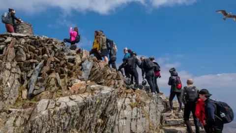 Getty Images People queuing at the top of Snowdon