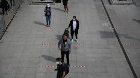 Reuters People are seen following social distancing rules as they queue outside a Tesco supermarket in Kensington, as the spread of the coronavirus disease (COVID-19) continues,