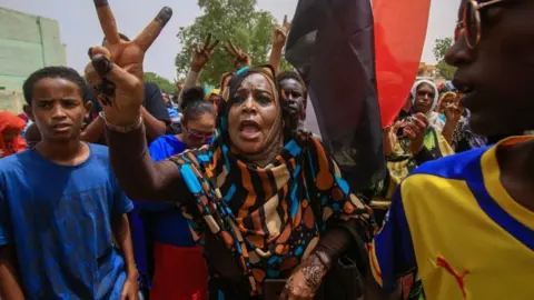 AFP A Sudanese protesters flashes the V-sign during a mass demonstration against Sudan's ruling generals in Khartoum on June 30 2019