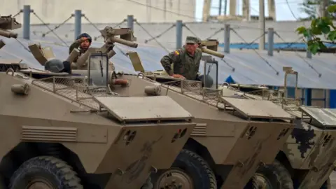 Getty Images Soldiers in armoured vehicles secure the Guayas 1 prison in Guayaquil, Ecuador