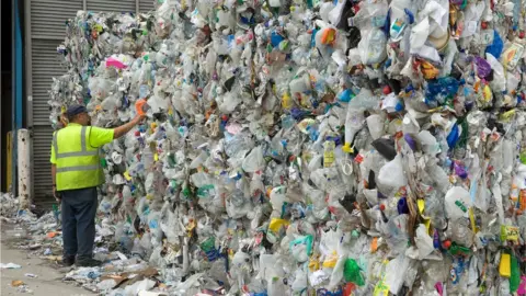 Getty Images A man examines bailed waste