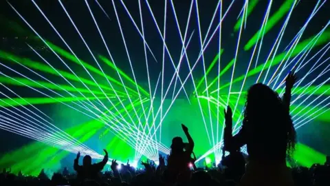 Sam Wheatland Woman in silhouette dancing at Calvin Harris set at Creamfields South 4 June 2022