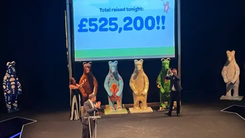 Bears of Sheffield People standing in front of bear statues at a charity auction