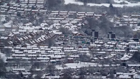 PA Media/Owen Humphreys Rows of houses with snow covered rooves at Gateshead