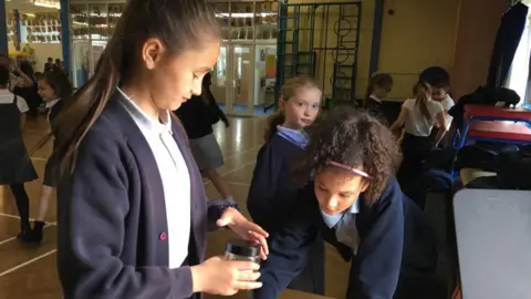 Paying 20p into the lunchtime disco jar