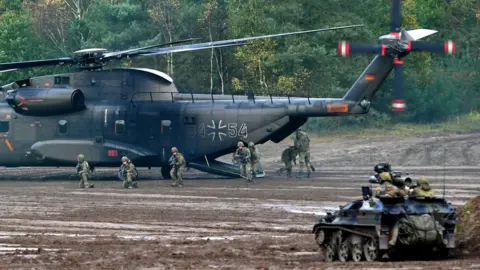 AFP A CH-53 heafy-lift transport helicopter of the German armed forces Bundeswehr operates in the context of an informative educational practice "Land Operation Exercise 2017" at the military training area in Munster, northern Germany.