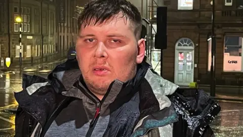 John standing on a Newcastle street