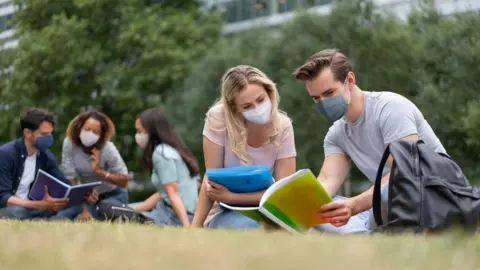 Getty Images Image shows students with masks