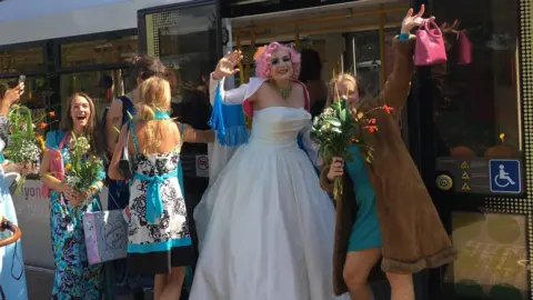 TfGM Kat Mulhall and her wedding party on a tram