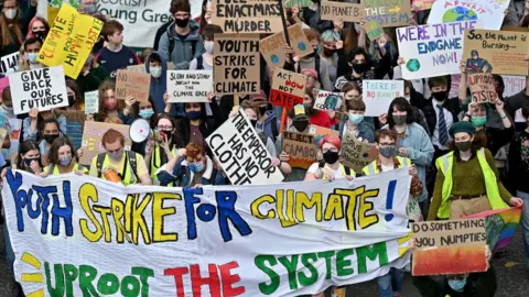 Getty Images Protestors in Glasgow march towards George Square