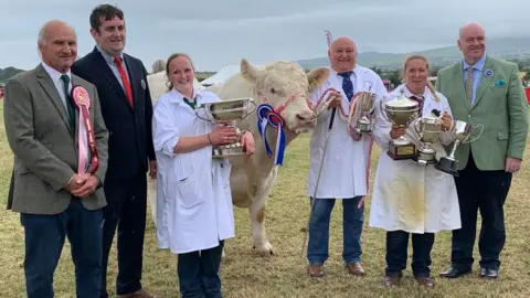 BBC Members of the Quine family with show officials the the chief minister, alongside the winning bull