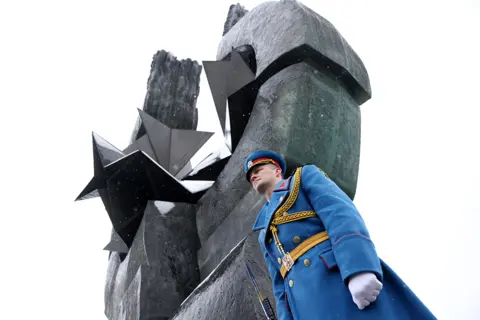 Andrej Cukic / EPA A member of the guard of honour of the Serbian Army stood at attention during a memorial service at the monument of victims of the Nazi concentration camp Sajmiste, in Belgrade, Serbia, on 27 January 2023