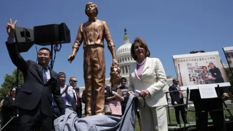 Getty Images Speaker Pelosi unveils a statue of the 'Tank Man' from Tiananmen Square at a rally with Chinese dissidents in 2019