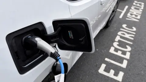 Reuters Generic image of an electric car being charged in London