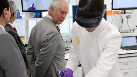 PA Media The Prince of Wales (left) receives a demonstration of how augmented reality helps with Hololens technology during a visit to AstraZeneca to officially open their new global Research and Development facility at the Cambridge Biomedical Campus