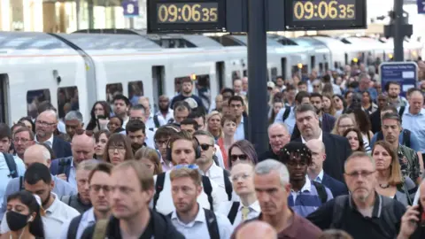 PA Media Passengers arrive at Kings Cross Station, London