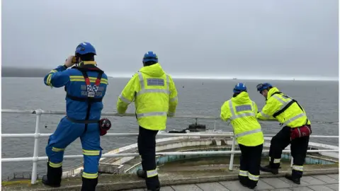 BBC A photo of emergency services at the scene