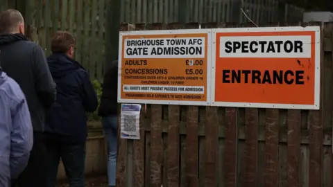Darren Murphy Fans queue to get into Brighouse Town AFC