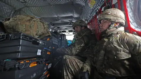 PA Soldiers inside a chinook taking supplies to Cumbria