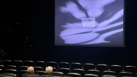 Peter Purves and Toby Hadoke sat in a cinema watching Doctor Who
